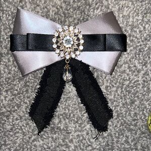 Elegant Black and Silver Bow Brooch with Crystal Accent